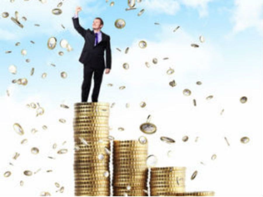 man standing on gold coins