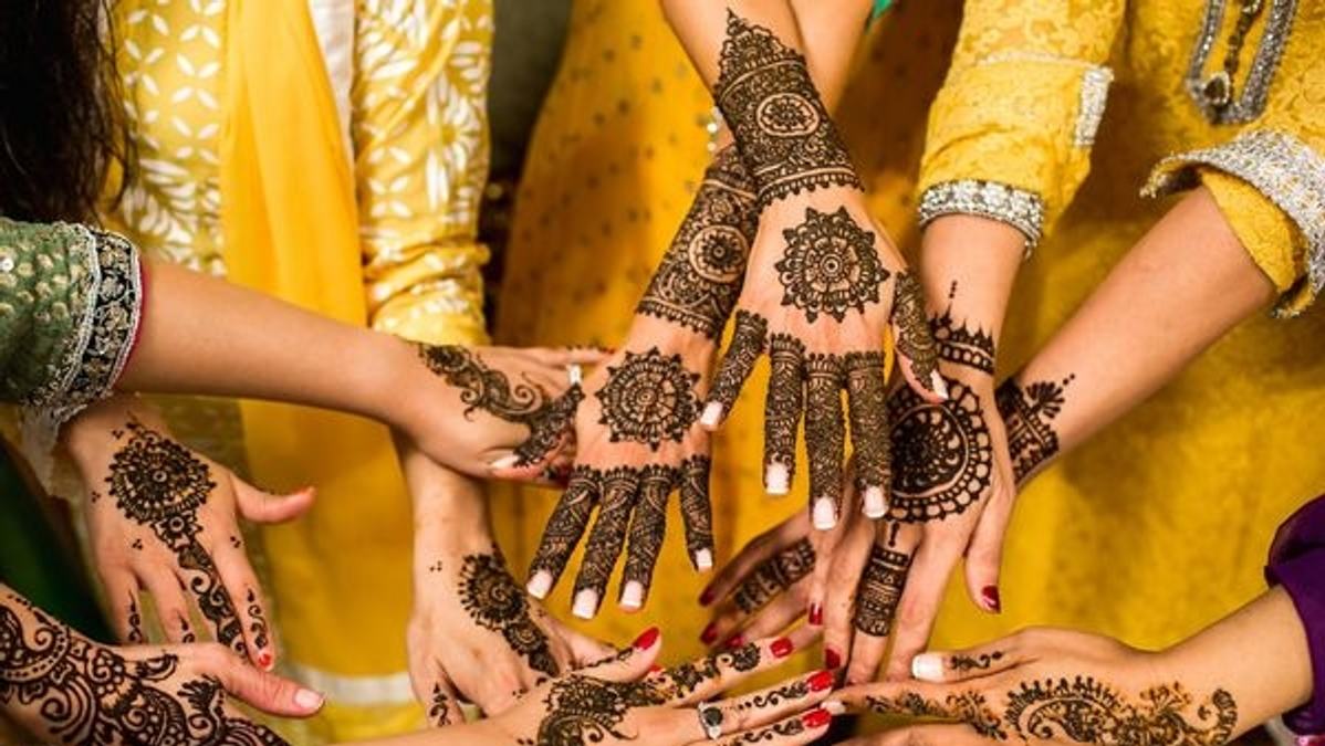 An Indian couple checking off items in their wedding checklist