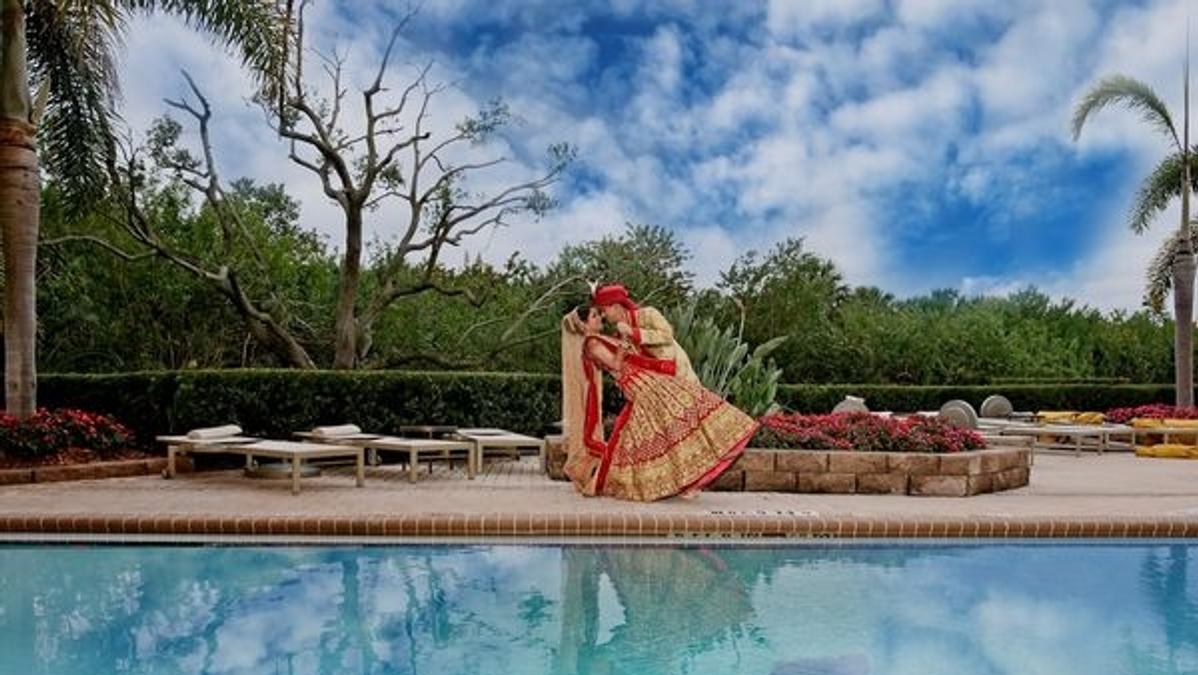 An Indian couple feeling satisfied after successfully planning their wedding budget