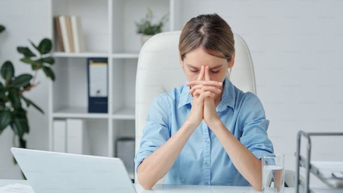 Illustration of a tired, stressed and overworked professional at a desk