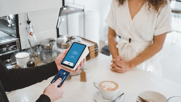 A happy person paying more than the minimum amount