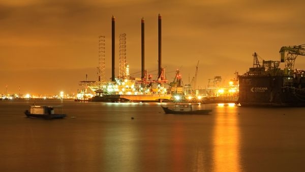 An image of a global map branded with oil barrels indicating the worldwide impacts of oil price changes