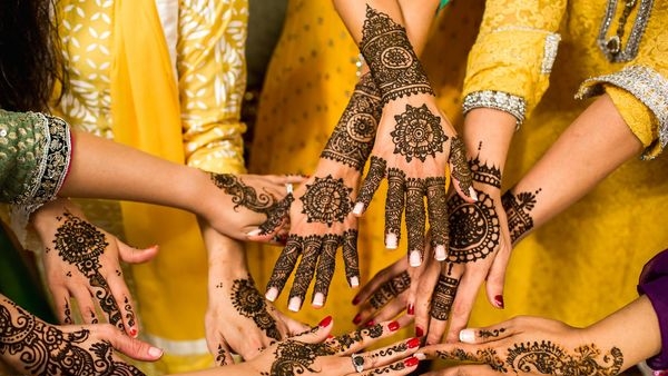 An Indian couple checking off items in their wedding checklist An Indian couple checking off items in their wedding checklist