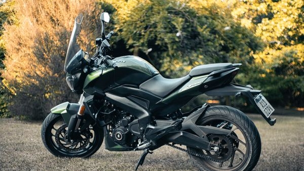 Bajaj Auto logo with a backdrop of growing sales chart