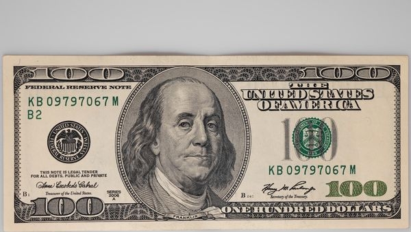 A close-up image of US dollar bills to represent reserve currency status