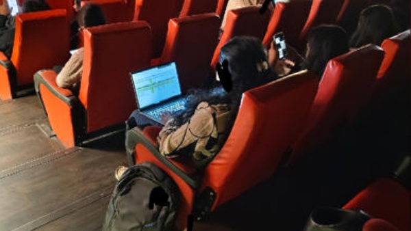 Bengaluru work culture work from cinema hall WFH in cinema woman working in movie theatre laptop in cinema hall work culture controversy Bengaluru work from anywhere trend Bengaluru news movie theatre etiquette public outrage Bengaluru remote work issues cinema hall work ethics WFH